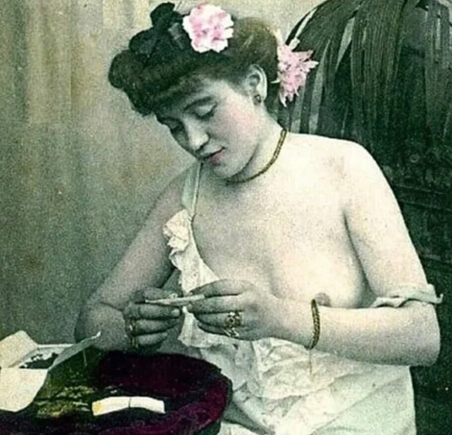 Victorian woman rolling a joint, 19th century hand-colored postcard