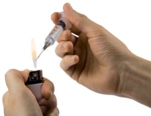 Heat the needle until it is red hot